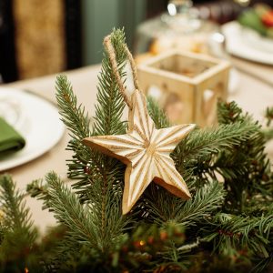 1. Hand-carved mango wood star decoration with whitewashed finish and yarn string, featuring a carved star texture in the centre