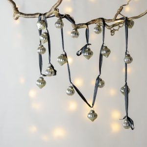 1. Ribbed silver bauble garland displayed on a black ribbon, ideal for decorating mantels, staircases, or Christmas trees