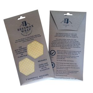 Set of 2 reusable beeswax sandwich wraps in yellow polka dot design, approx. 24 x 24 cm, made in the UK from cotton, beeswax, tree gum, and jojoba oil.