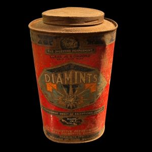 Vintage DIAMINTS peppermint tin with red and teal graphics, diamond motif, and aged patina, 26cm tall with stuck screw-top lid.