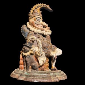 1. Antique Victorian cast iron door porter depicting Mr Punch and Toby seated on books with original paint