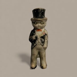Bisque figurine of a gentleman in a top hat with hand-painted glasses and coat, marked “Made in Japan” on the back.