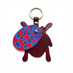 Red bug leather key fob with blue spots and gold ring