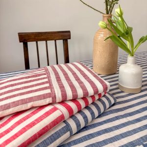 Woven striped cotton tablecloth with contrasting border detail available in Poppy, Clay or Indigo